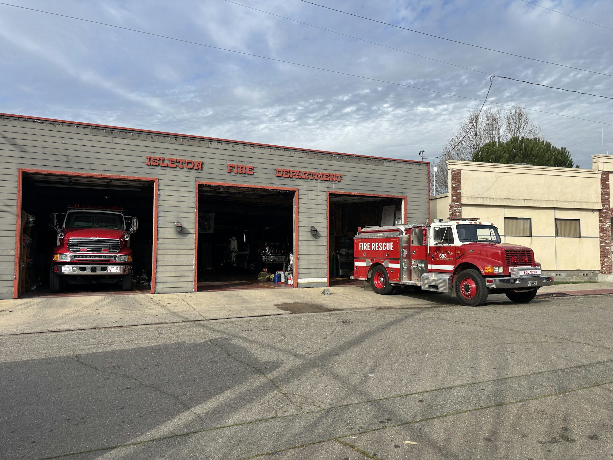 Two fire trucks in front of the Isleton Fire Department building.