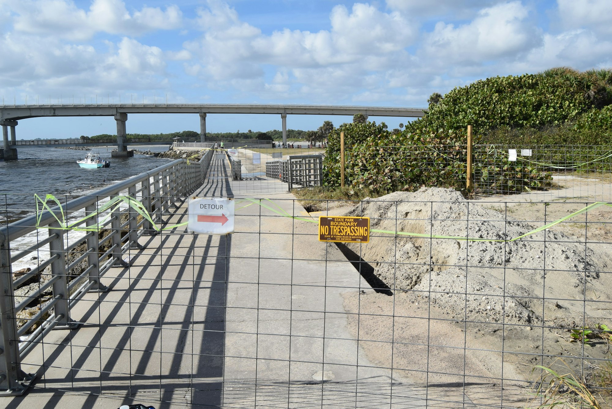 May contain: water, waterfront, railing, pier, path, handrail, boat, transportation, vehicle, person, and road