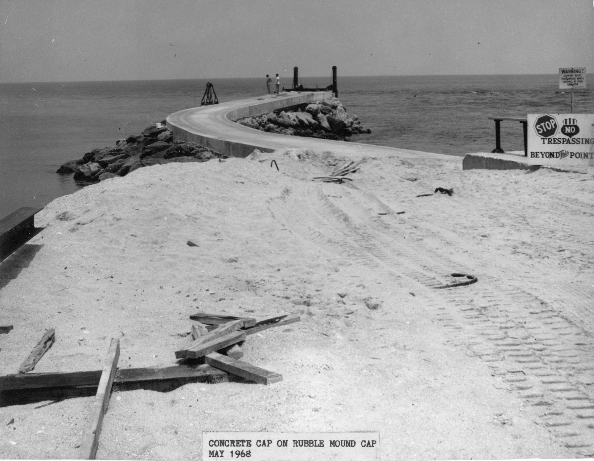 view of north jetty construction site in 1968 as it begins to jut out into the ocean