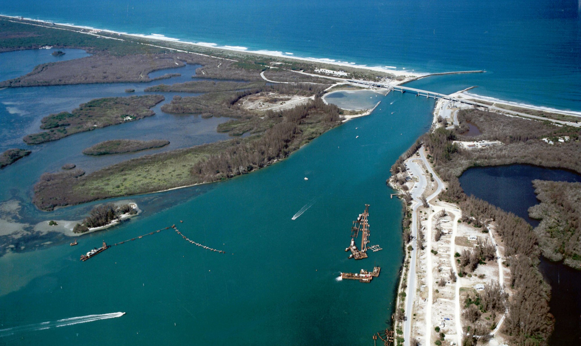 aerial view of inlet looking East with dredging equipment in channel