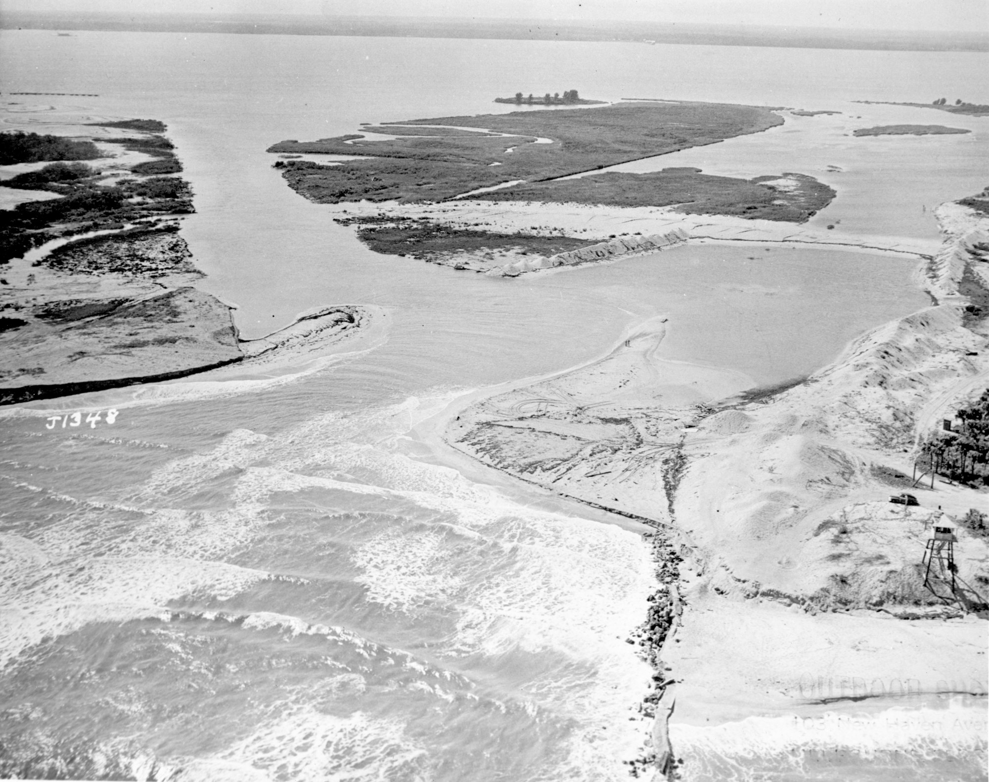 Aerial view of the open inlet from 1948 showing the connection of the Indian River and Atlantic Ocean