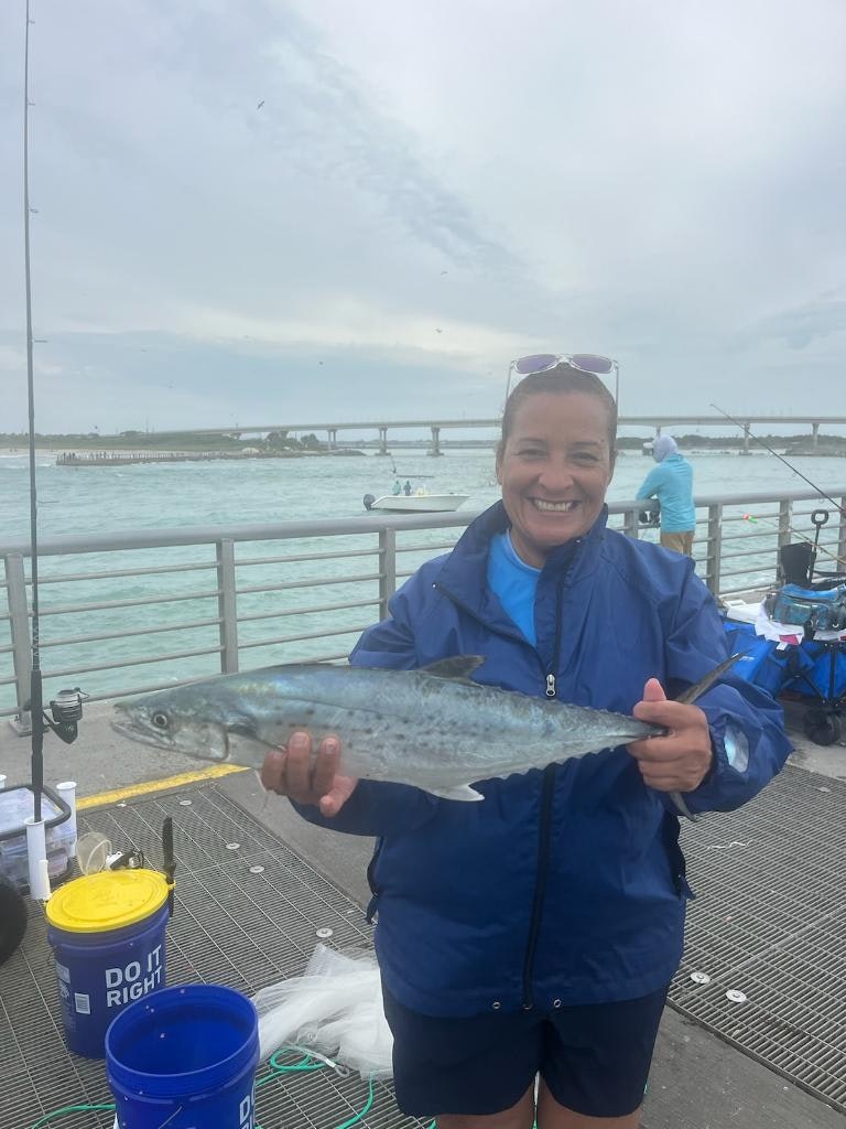 May contain: water, waterfront, animal, fish, sea life, tuna, bonito, face, head, person, photography, portrait, clothing, coat, fishing, leisure activities, outdoors, shorts, and jacket
