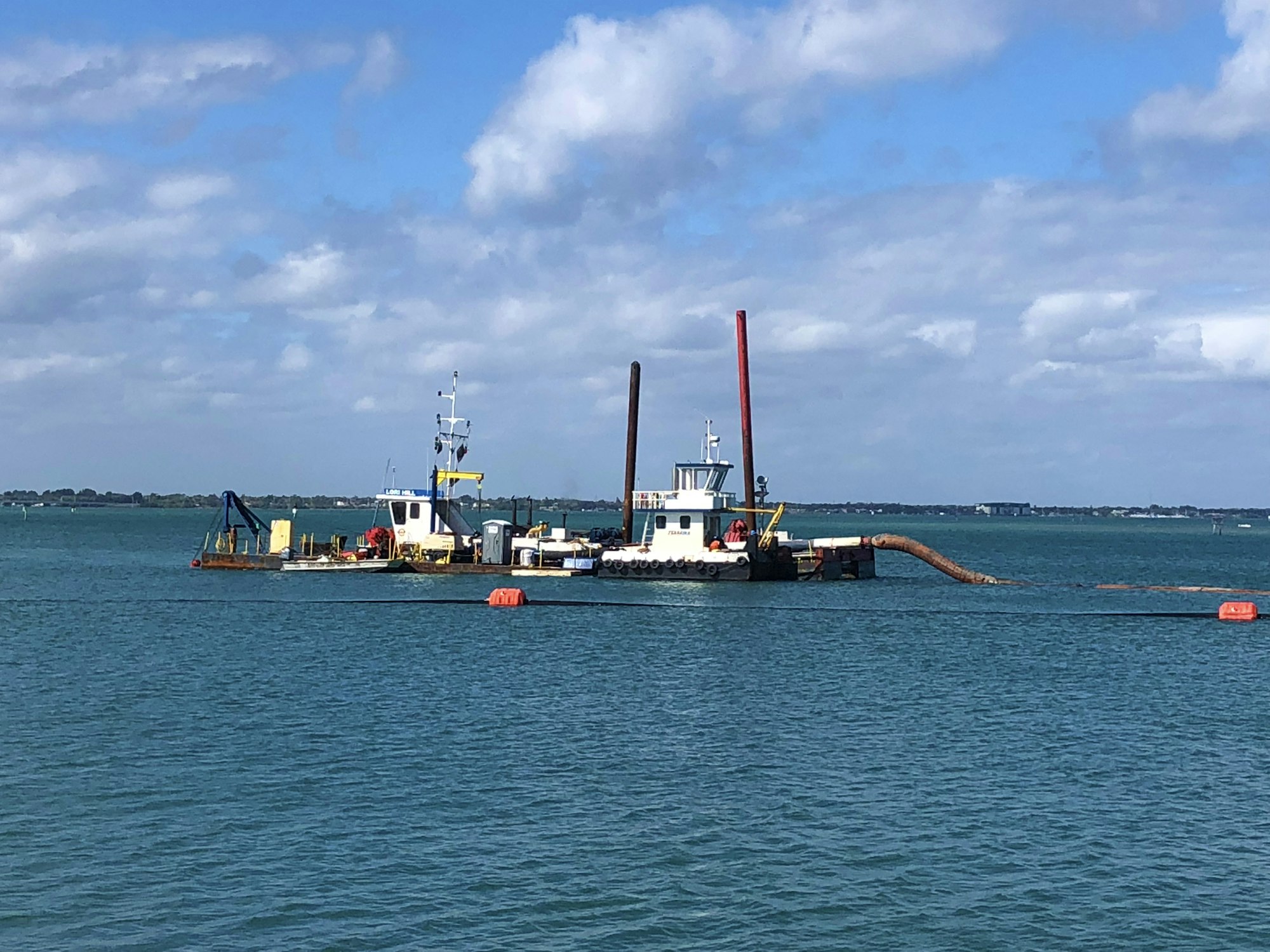 Dredge boat floating on water