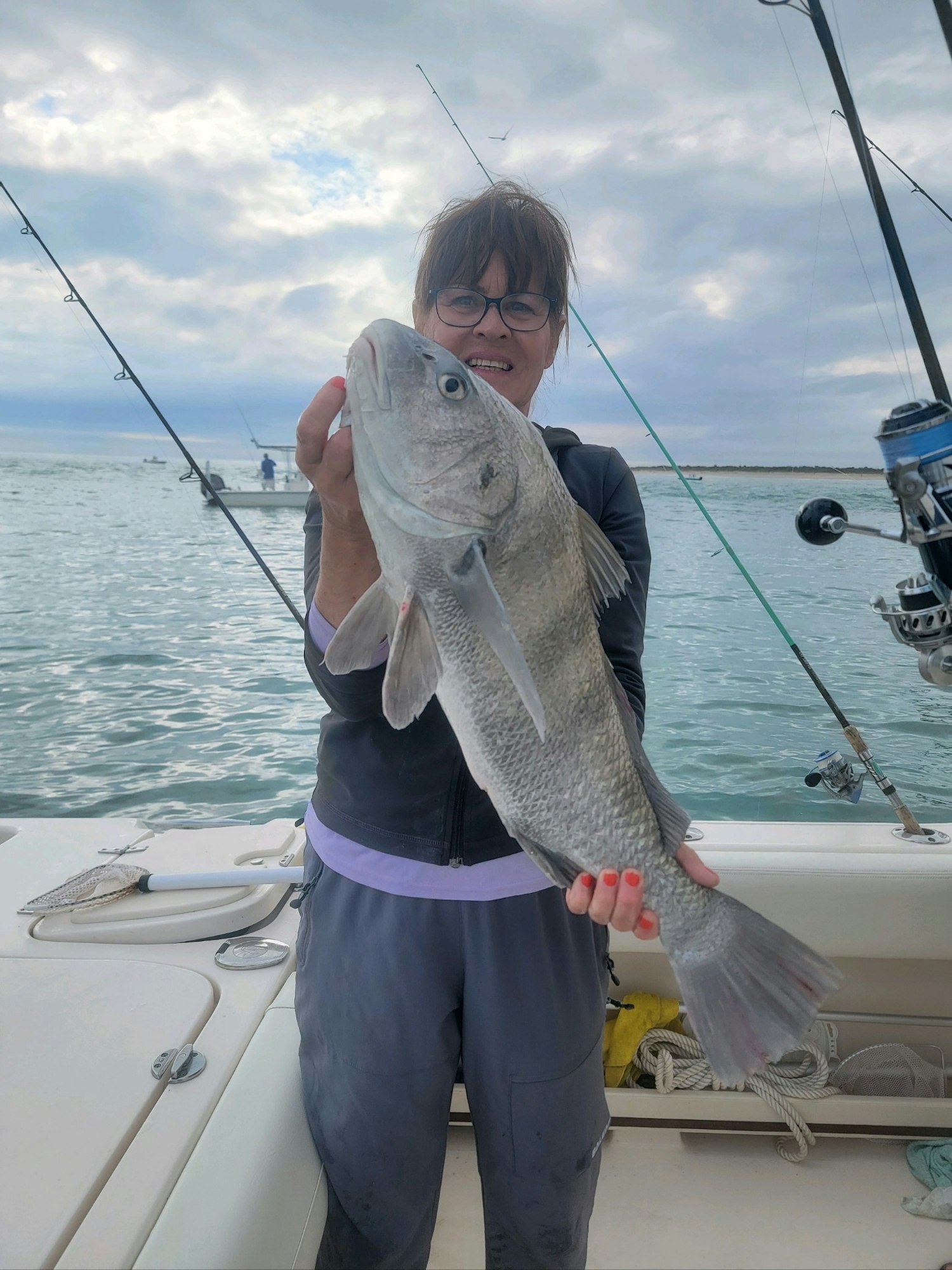 May contain: fishing, outdoors, water, leisure activities, person, glasses, and accessories