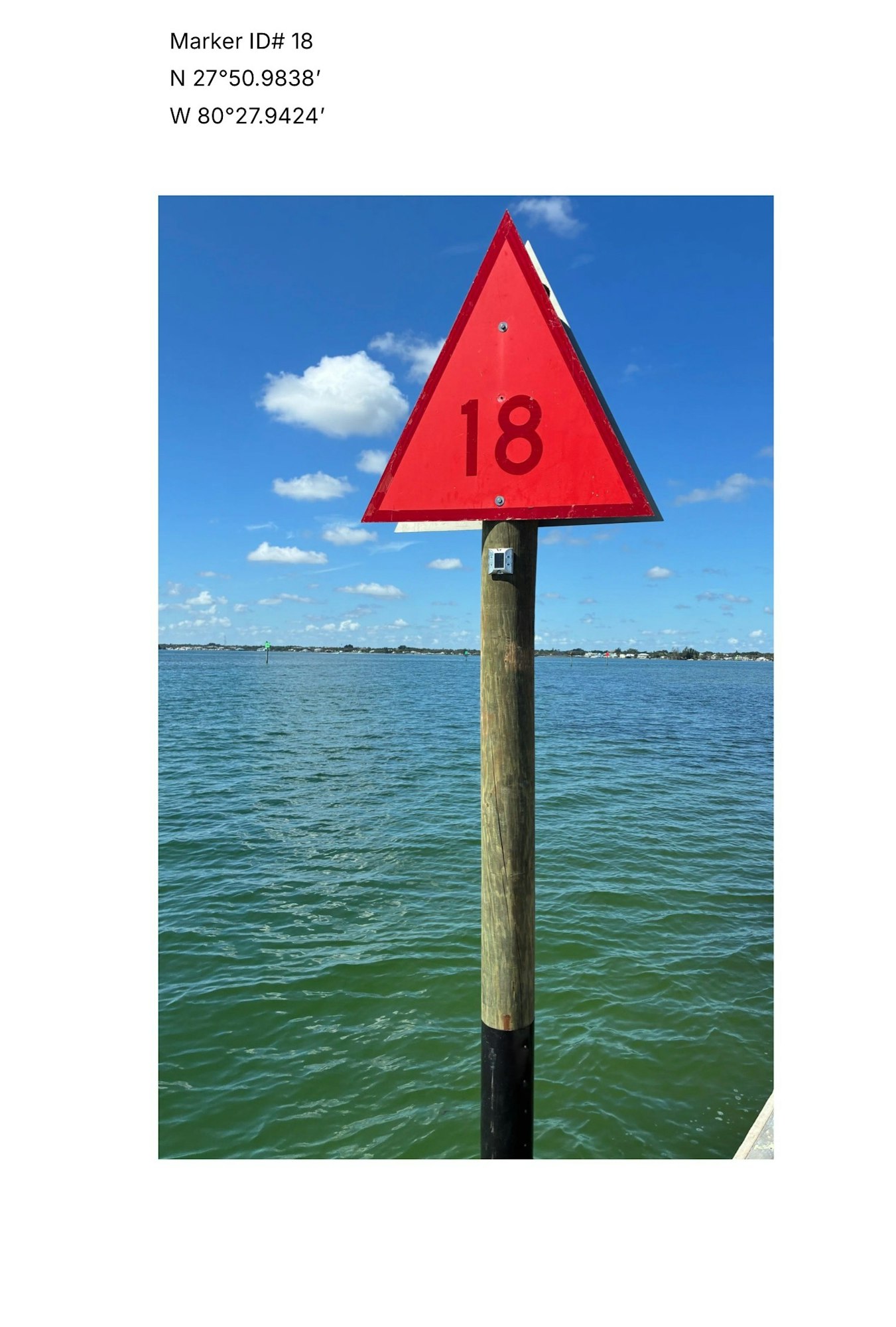 A red triangular marker labeled "18" in water, with coordinates N 27°50.9838' and W 80°27.9424'. Skies are blue with clouds.