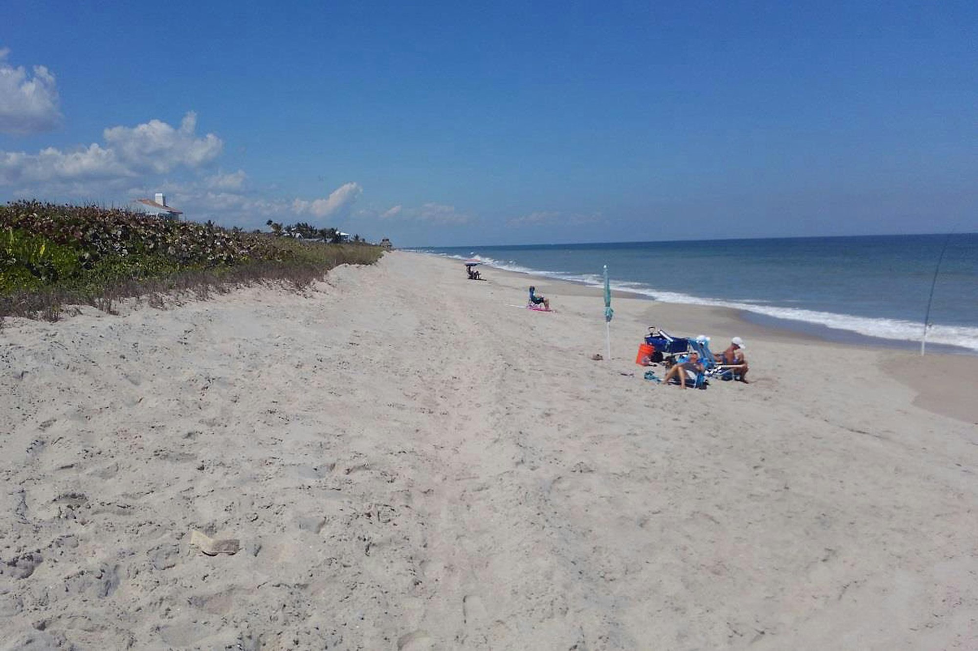 view of Ambersand beach looking North with several beach goers