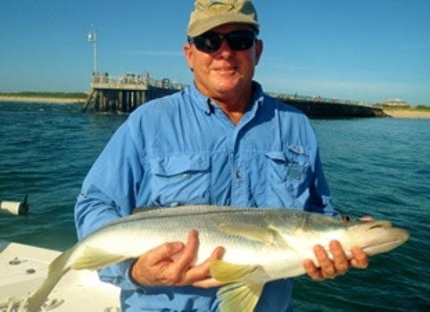 Michael Rowland holding fish in front of North Jetty