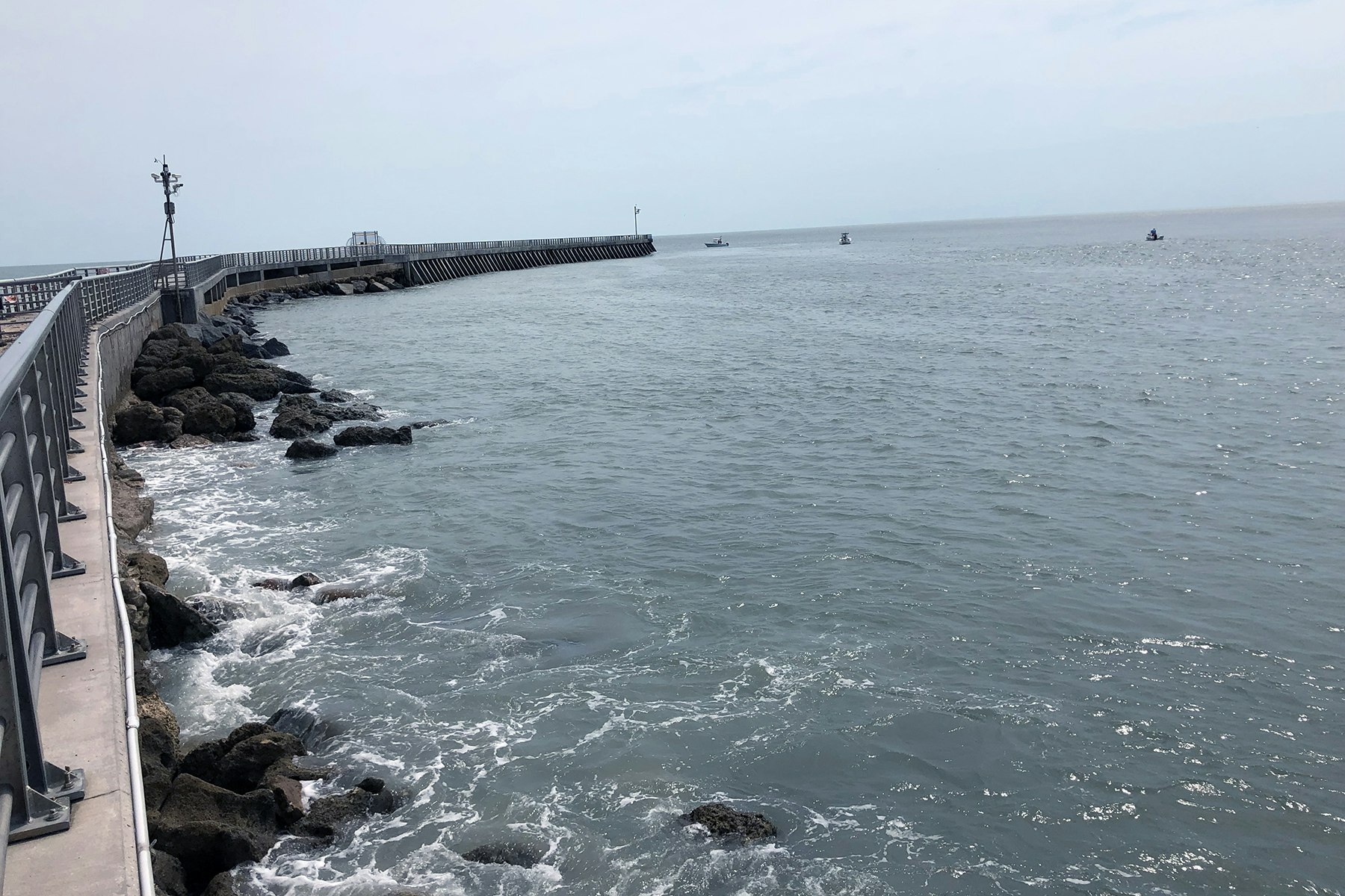 Post-storm site survey image showing dislodged armor stone at North Jetty.