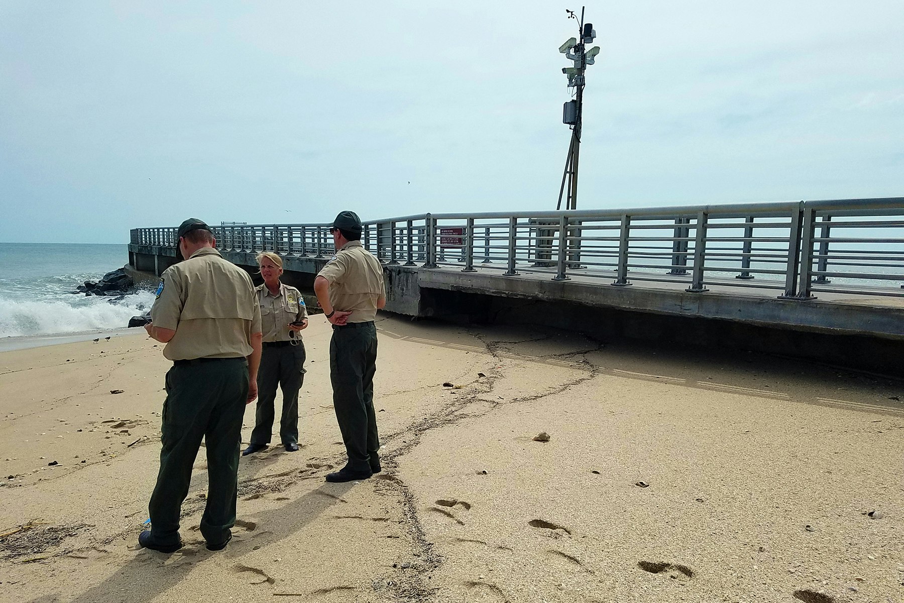 State Park officials inspecting the base of the North Jetty