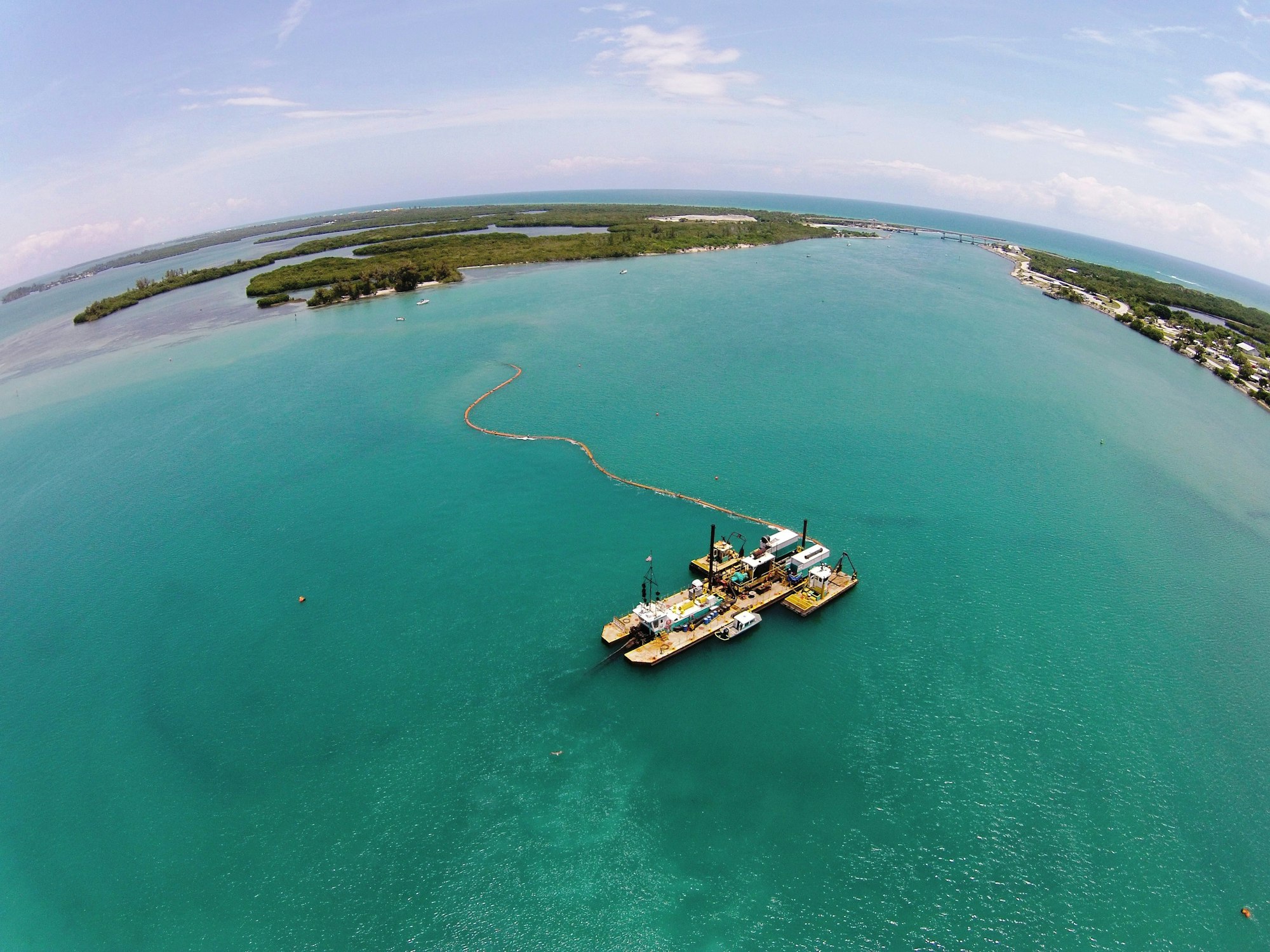 aerial view of dredge floating over inlet channel