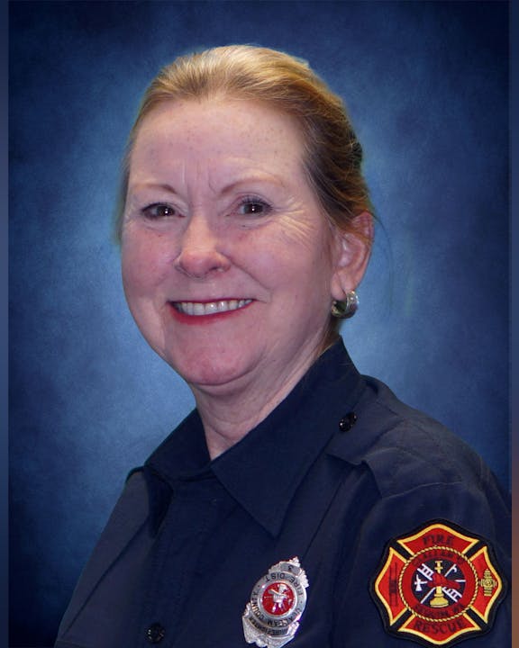May contain: badge, logo, symbol, captain, officer, person, adult, female, woman, face, head, and police officer