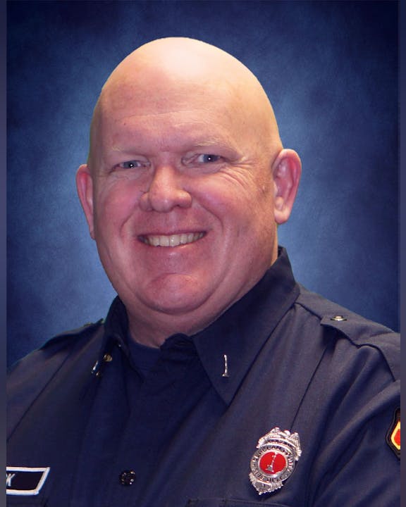 May contain: captain, officer, person, police officer, face, head, photography, portrait, badge, logo, and symbol