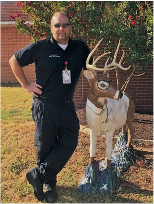 Taylor K. Ratcliff, MD, FACEP, FAEMS, FF/EMT-P EMS Physician & Medical Director posing with  a deer