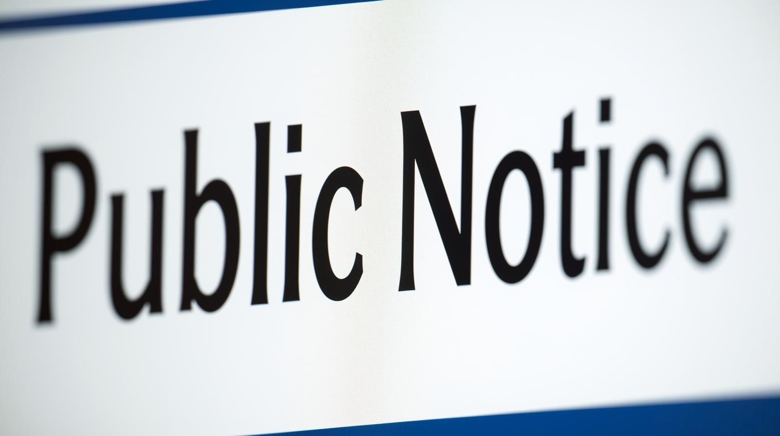 The image features a close-up of a sign displaying the words "Public Notice."