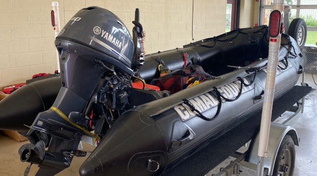 Black inflatable boat with a Yamaha motor on a trailer, labelled "GEMINI".