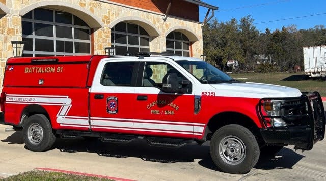 A red fire department utility truck labeled "Battalion 51" parked outside a building.