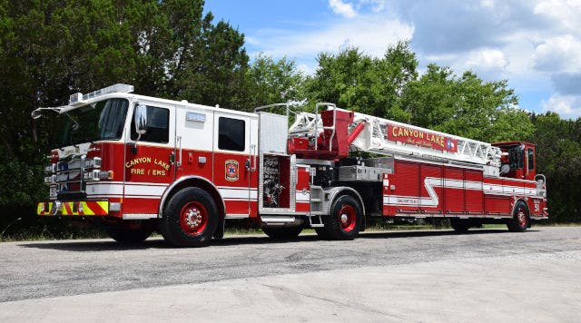 A red fire truck parked outside, labeled "CANYON LAKE FIRE / EMS."