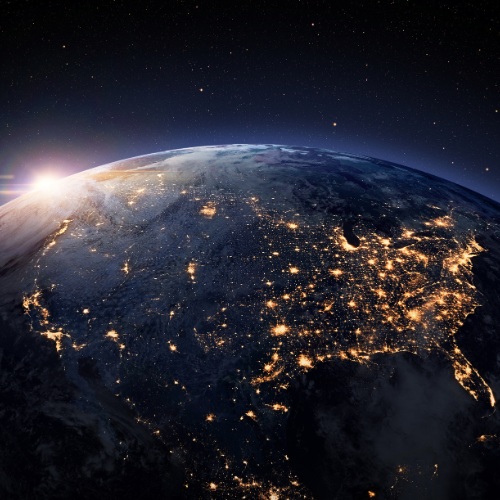 A stunning view of Earth from space, showing illuminated cities and a glowing atmosphere against a starry backdrop.