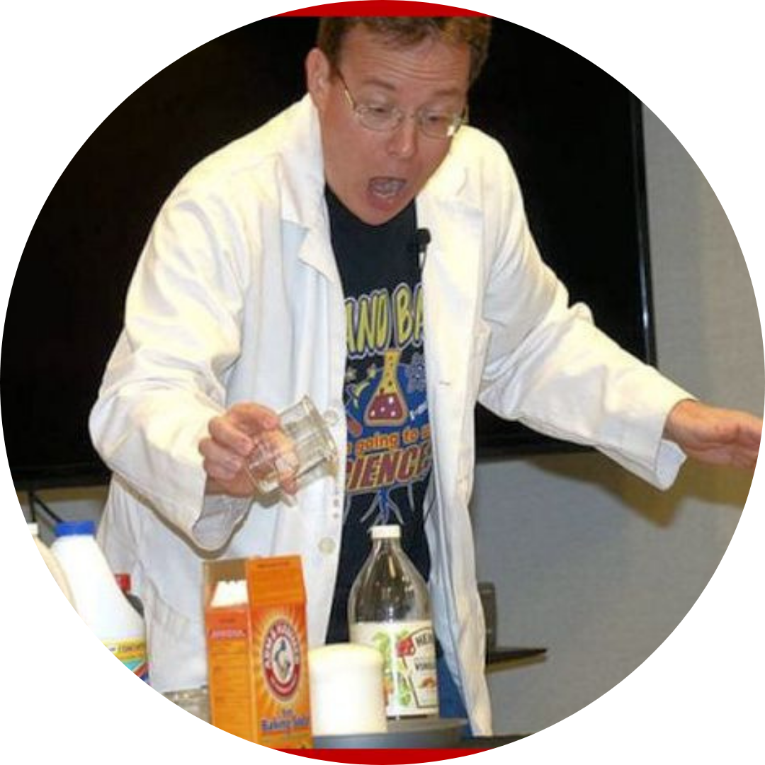 A person in a lab coat enthusiastically conducting a science experiment with vinegar and baking soda.