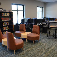 May contain: book, indoors, library, publication, chair, furniture, room, waiting room, and table
