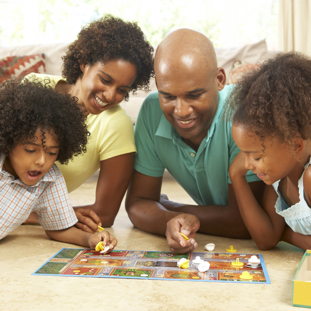 A family playing a board game together, smiling and enjoying their time.
