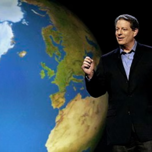 A speaker is presenting with a globe in the background, possibly discussing environmental issues or climate change.