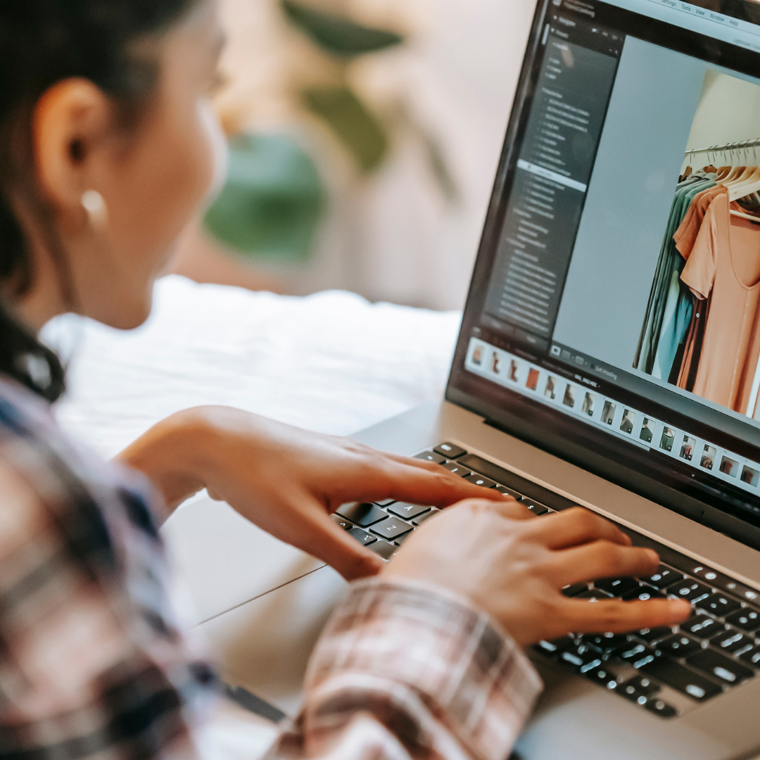 Person editing clothing photos on a laptop.