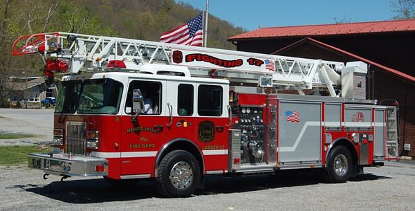 May contain: flag, fire truck, transportation, truck, vehicle, person, and car