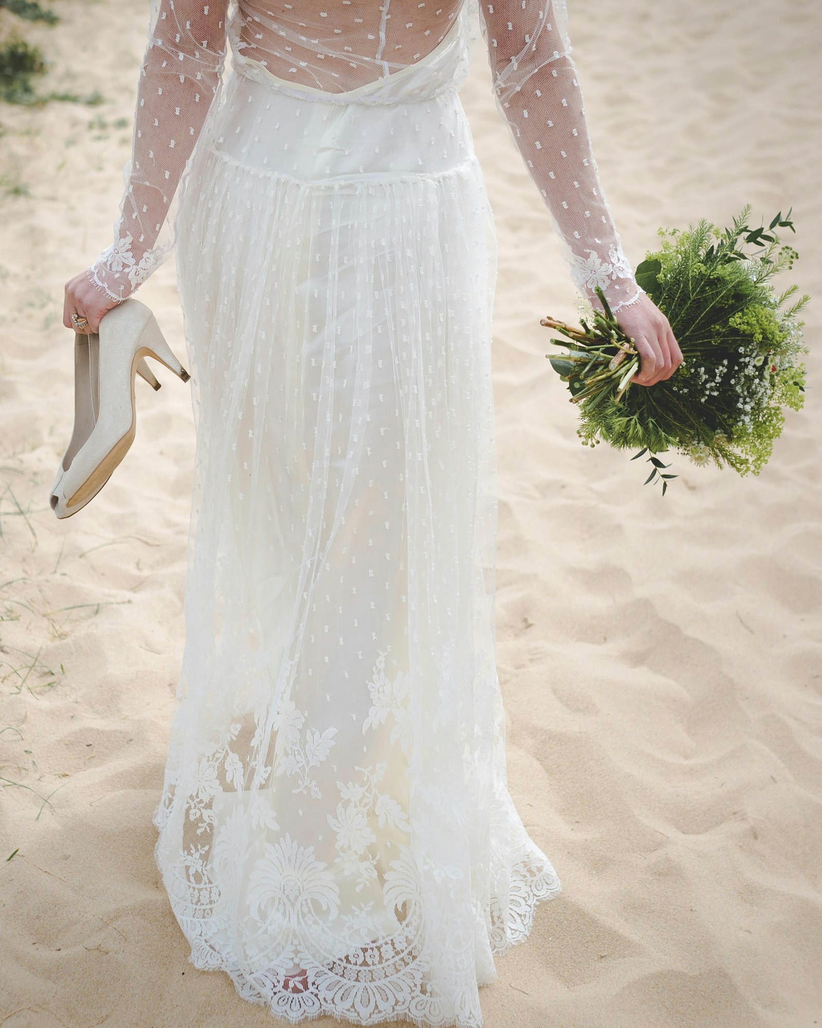 May contain: clothing, dress, fashion, formal wear, gown, wedding, wedding gown, flower, flower arrangement, flower bouquet, plant, footwear, high heel, and shoe