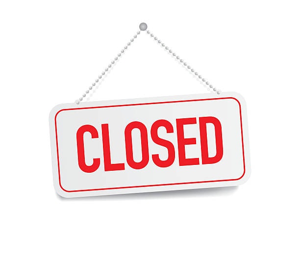 A sign that says "CLOSED" in red letters, typically indicating that a business is not open.