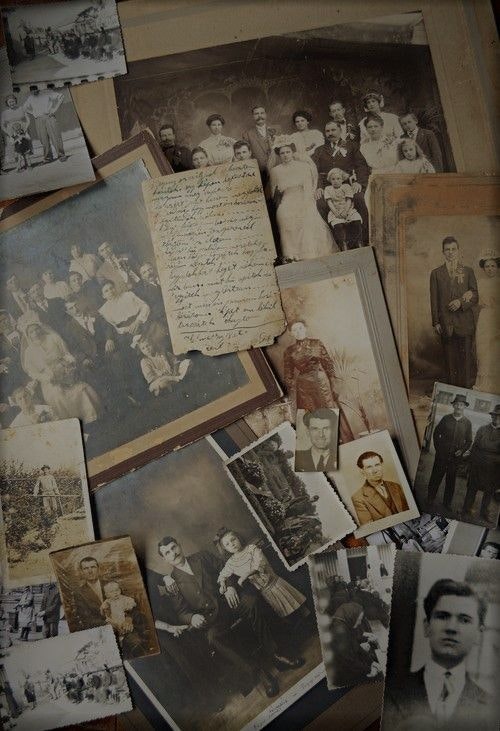 Old black-and-white family photographs and a handwritten letter are scattered across a surface.