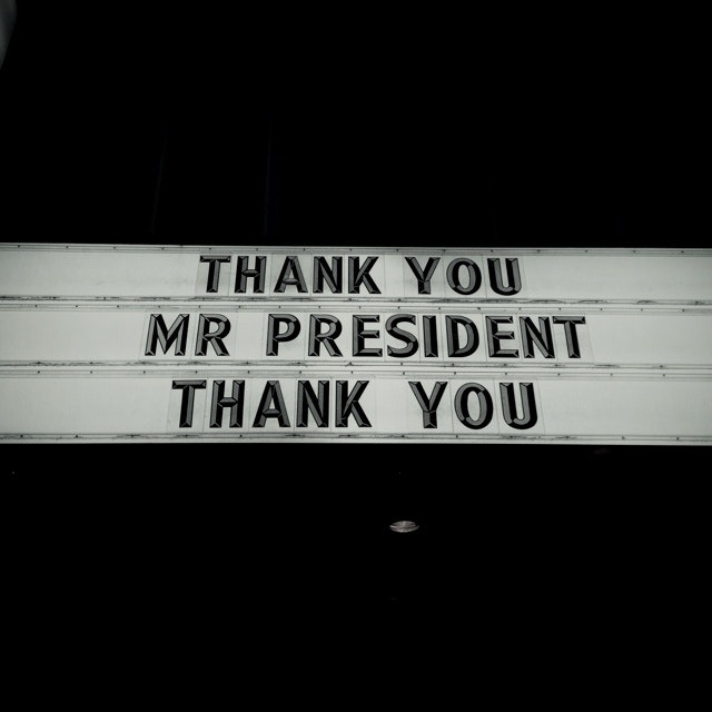 A sign with the text "THANK YOU MR PRESIDENT THANK YOU".