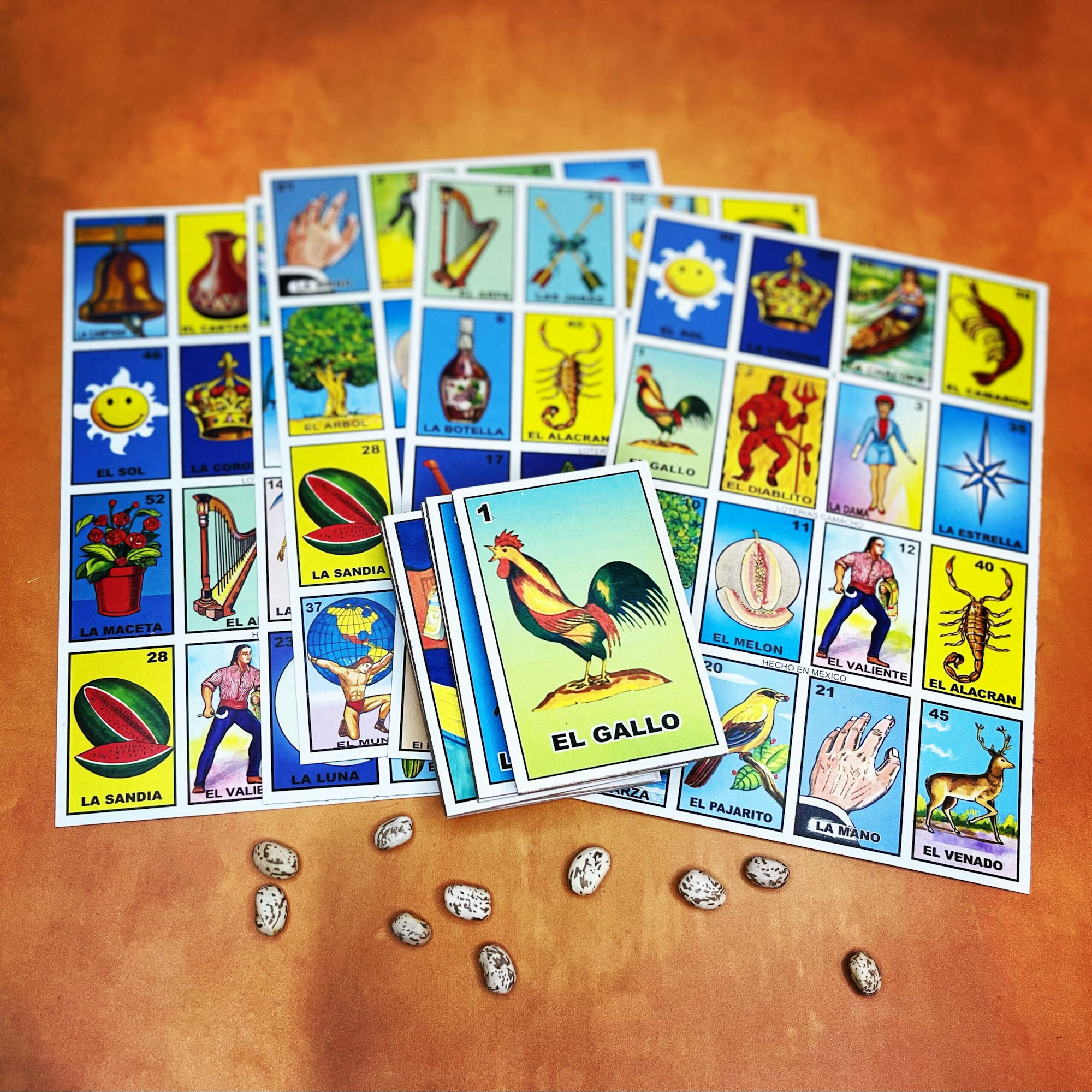 Lotteria game cards spread out with beans for markers.