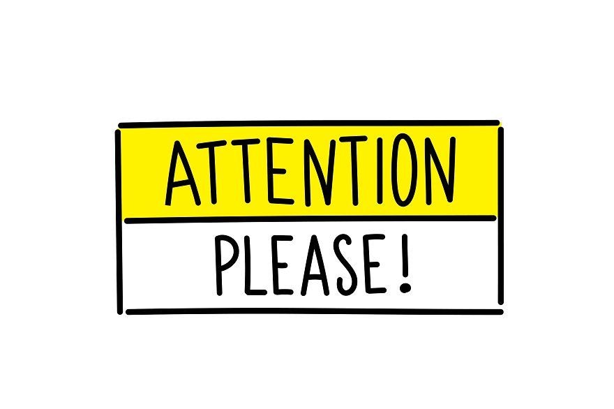 A yellow and white sign saying "ATTENTION PLEASE!" in bold black letters.