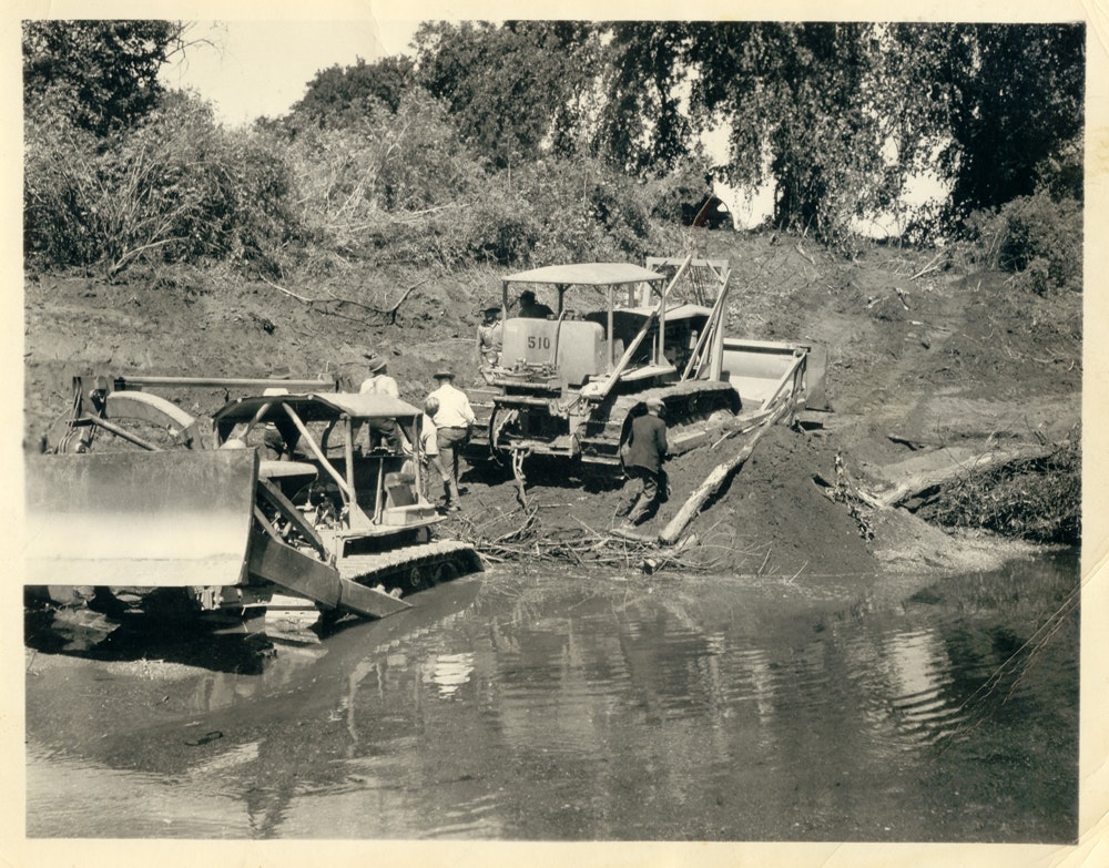 May contain: transportation, tractor, vehicle, person, human, and bulldozer