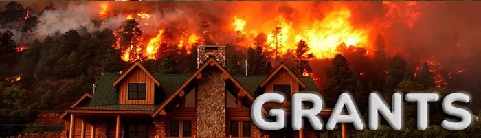 A large house with a green roof in front of a forest fire, with the word "GRANTS" in bold letters.