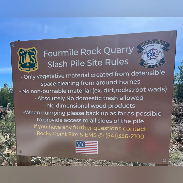 Sign outlining rules for the Fourmile Rock Quarry slash pile: only vegetative material allowed; no trash or non-burnable items.