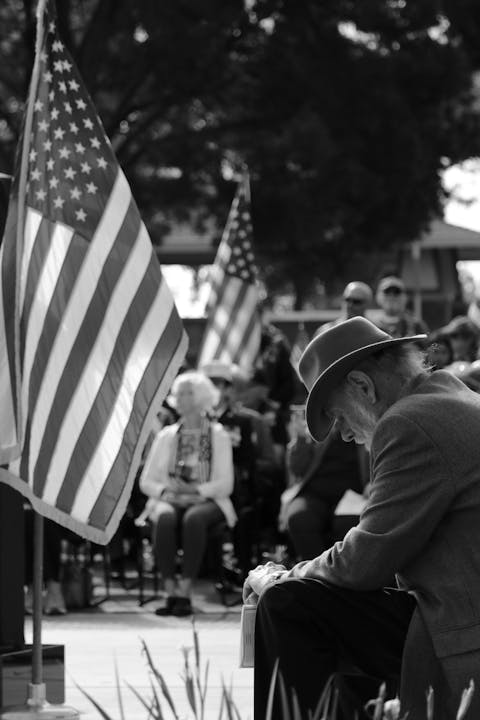 May contain: hat, clothing, flag, person, man, adult, male, and sun hat