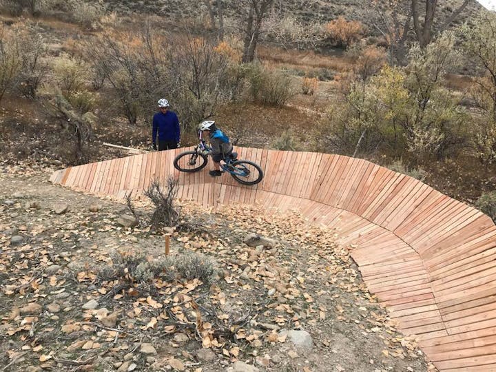 May contain: slope, bicycle, transportation, vehicle, person, mountain bike, and helmet