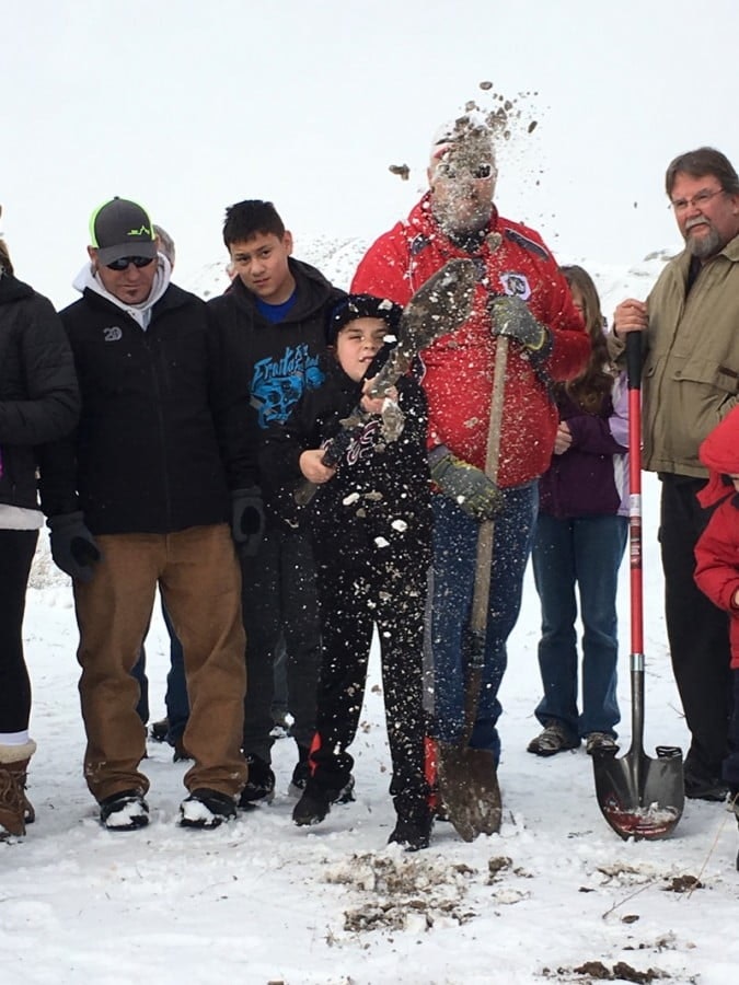 May contain: nature, outdoors, clothing, glove, boy, male, person, teen, snow, coat, jacket, device, shovel, and tool