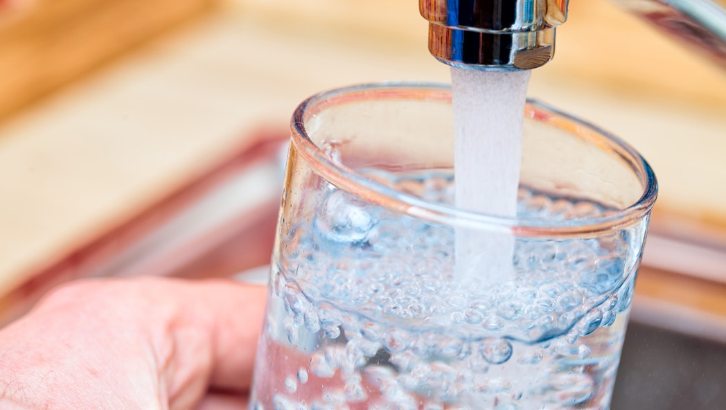 water glass filling from tap