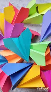 Colorful paper airplanes arranged together.