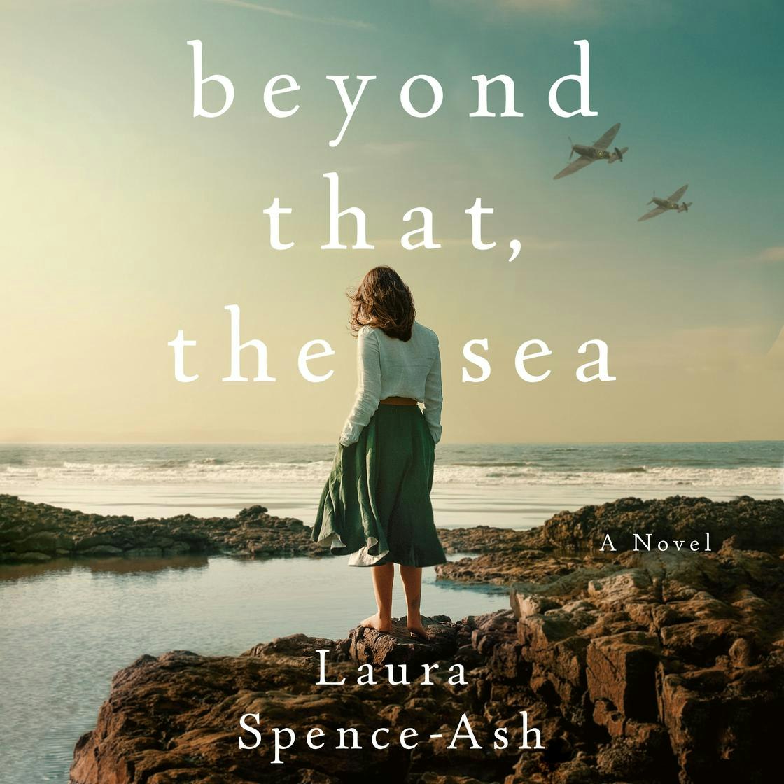 A woman stands on rocks by the sea with airplanes in the sky. Text reads: "Beyond That, the Sea" by Laura Spence-Ash.