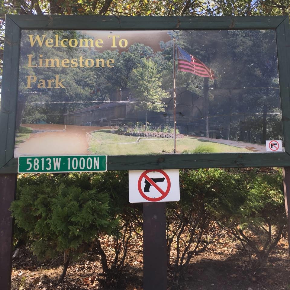 Sign for Limestone Park with a no-guns symbol and coordinates 5813W-1000N.