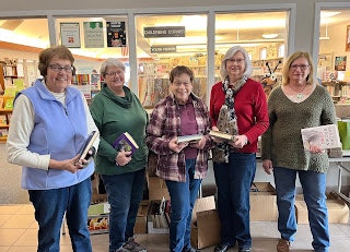 May contain: book, publication, bookstore, shop, indoors, library, clothing, knitwear, sweater, person, hoodie, sweatshirt, and coat