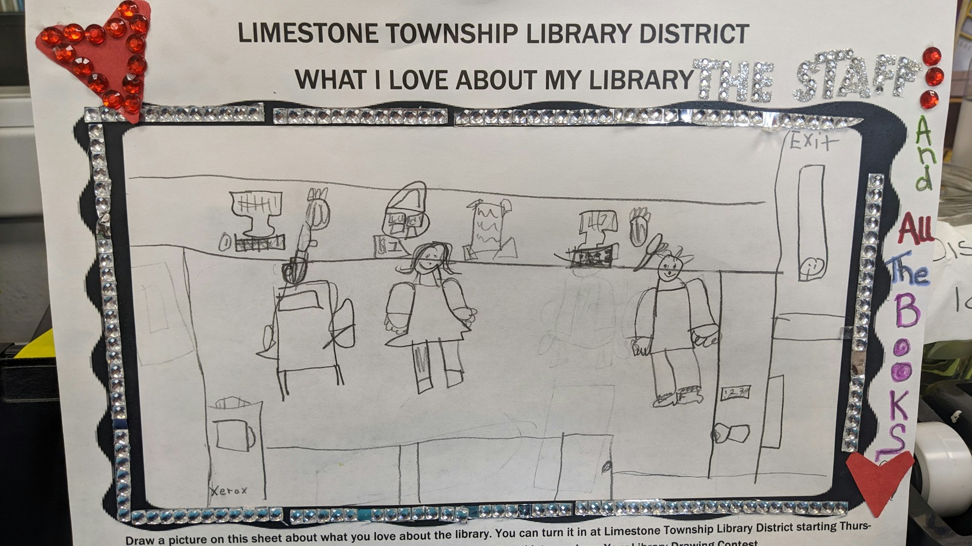 Child's drawing of a library with people, books, and a caption expressing love for the library and staff.