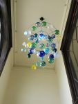 Colorful glass chandelier hanging from a ceiling.