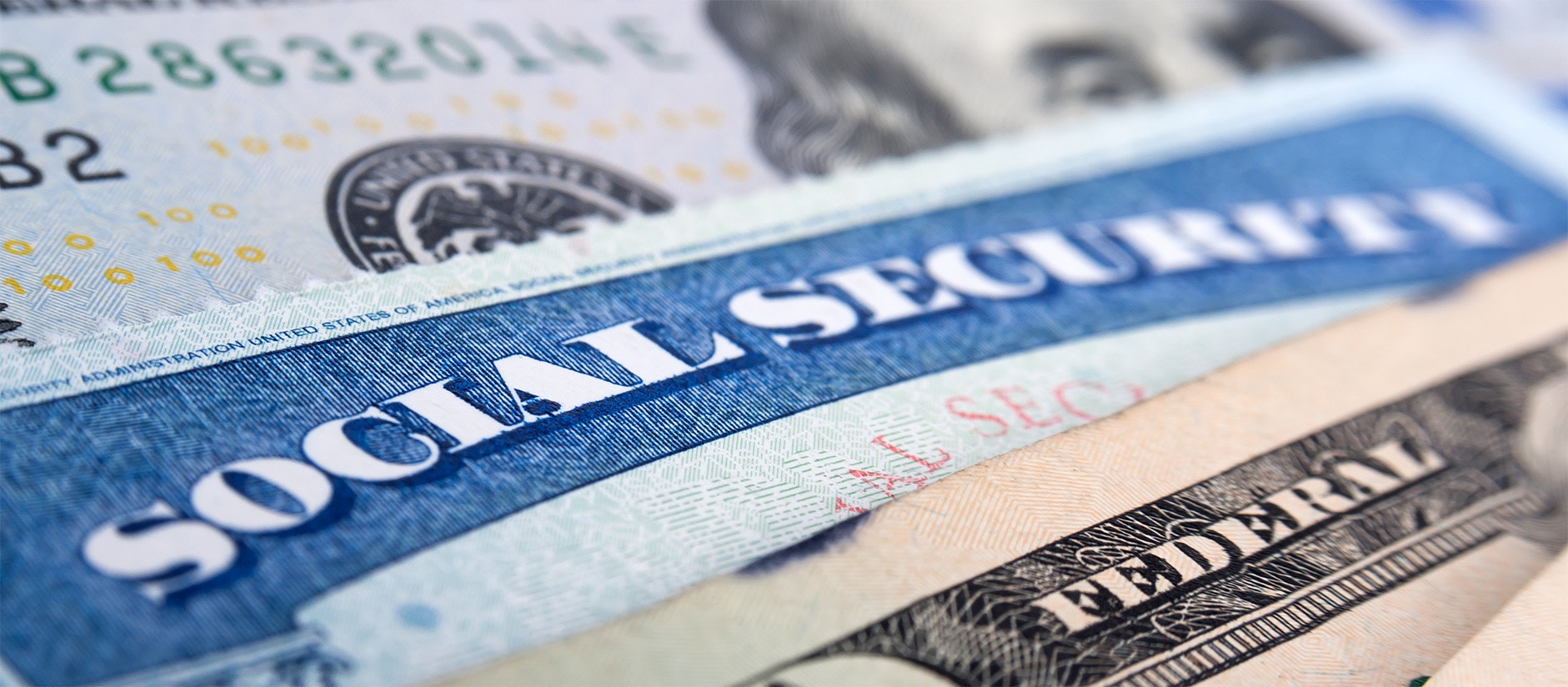 Close-up of a Social Security card and dollar bills.