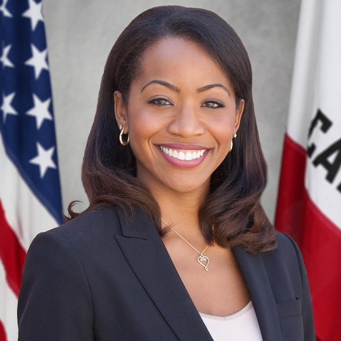 Malia Cohen standing between American and California flags