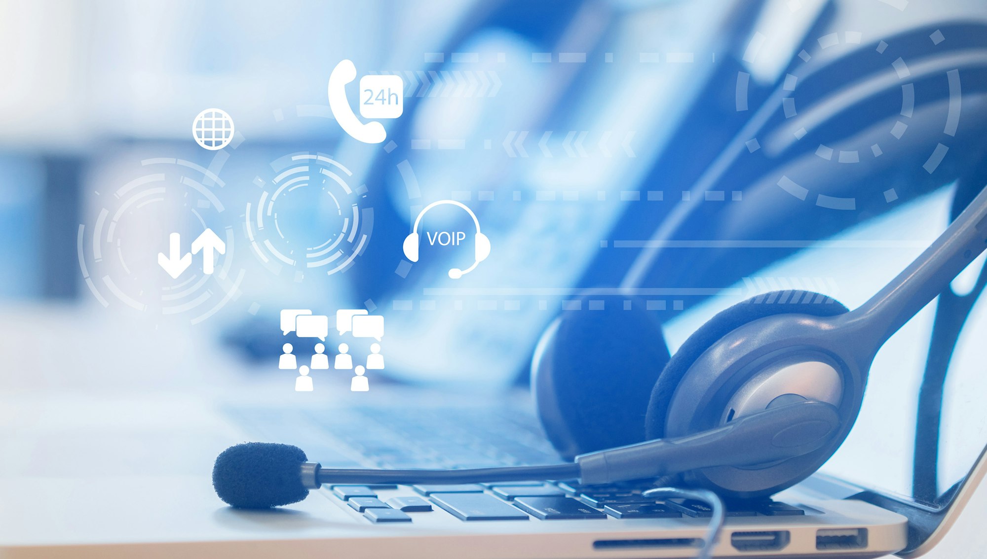 Headset on a laptop with digital icons for VoIP and customer support elements.